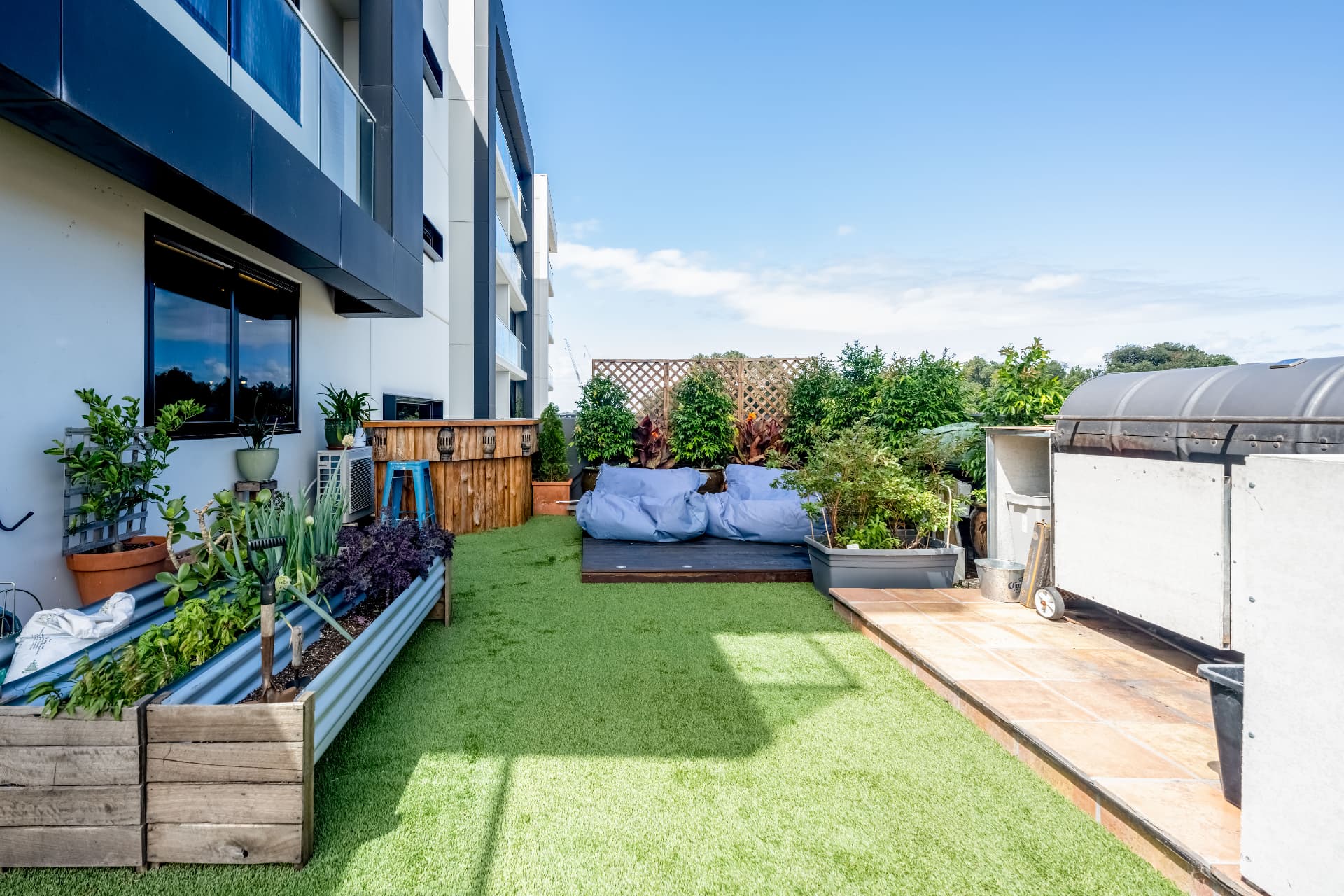 Terrace lawn with raised vegetable beds and daybed